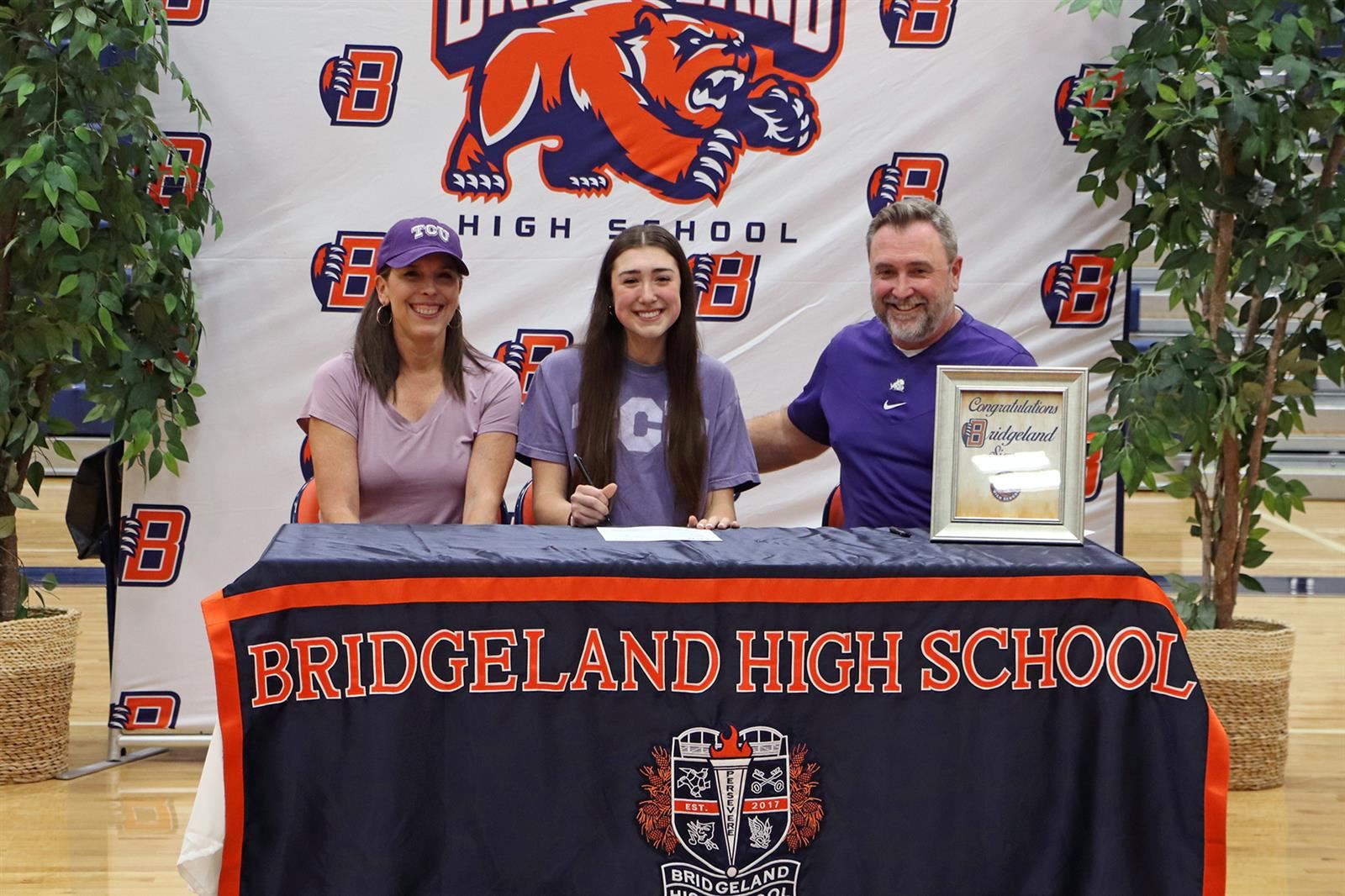 Bridgeland High School senior Alice Volpe, center, signed her letter of intent to play volleyball at Texas Christian.